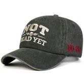 Unisex NOT DEAD YET Embroidery Wash Baseball cap featuring stylish embroidery on dark fabric.